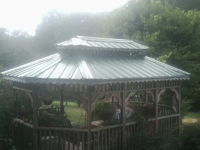 Two tier green metal roof on a garden gazebo in Stratham